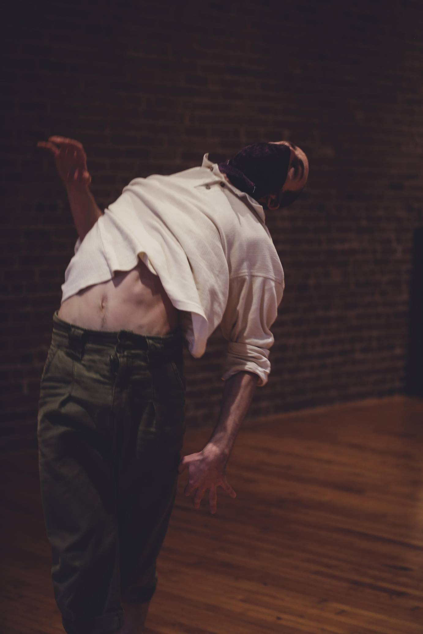 Jason Cianciulli arches backward, part of his stomach exposed